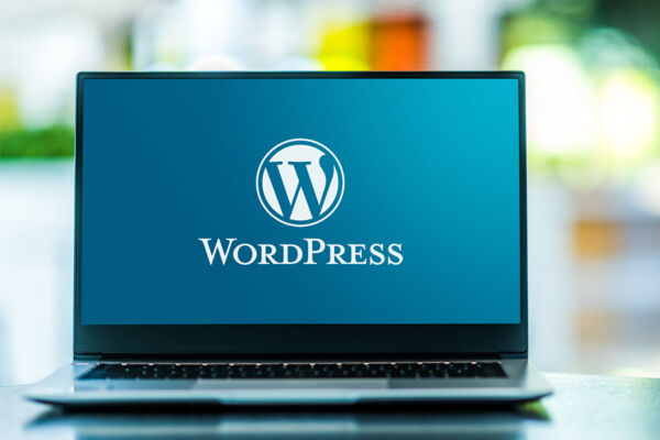 A WordPress logo displayed on a laptop screen, highlighting the importance of Top Hosting Providers for WordPress websites