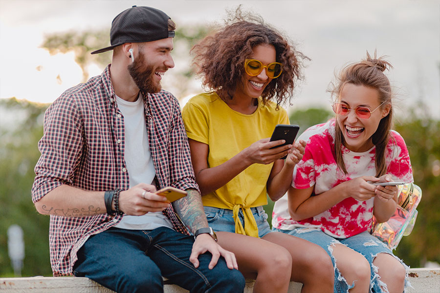 group of people smiling while using a mobile device concept image for seamless user experience of a wordpress site