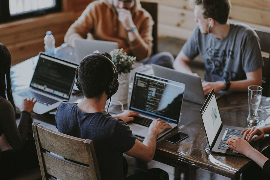 How To Scale Your Wordpress Design Agency 3 wordpress web designers during a meeting about improving their design and development services.
